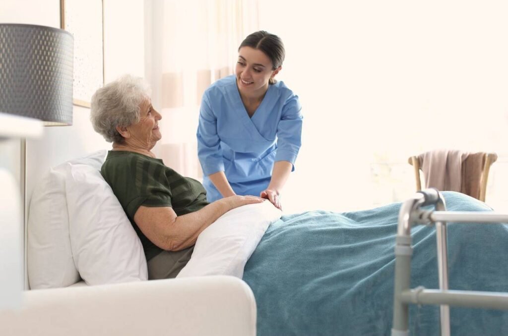 A nurse assists an elderly woman in bed