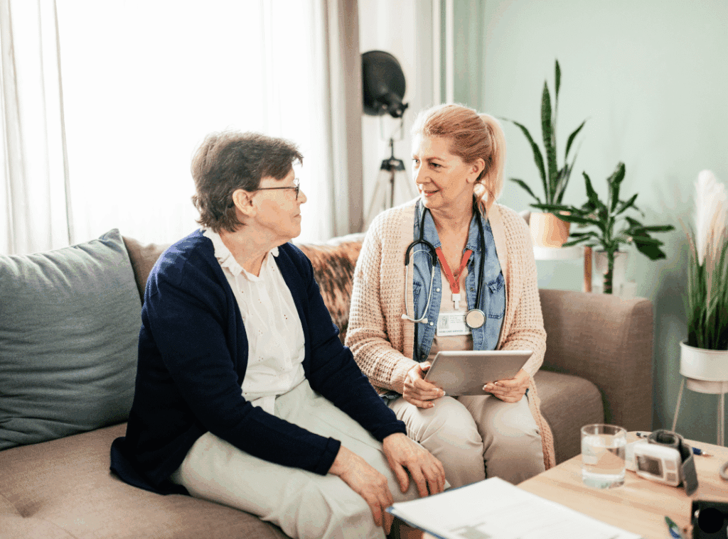 A woman and her friend chatting comfortably on a couch.